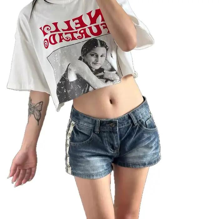 Shorts en jean taille basse brodés ailes d'ange et rivets style femme hot pants tendance Spicy Girl nouvelle collection été 2026