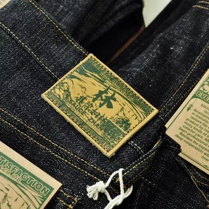 Jean en denim brut SauceZhan pour homme, coupe loose, 16.8 oz, boutons plaqués argent, style vintage, matériau canvas, adapté aux quatre saisons, pour un usage quotidien et occasions spéciales